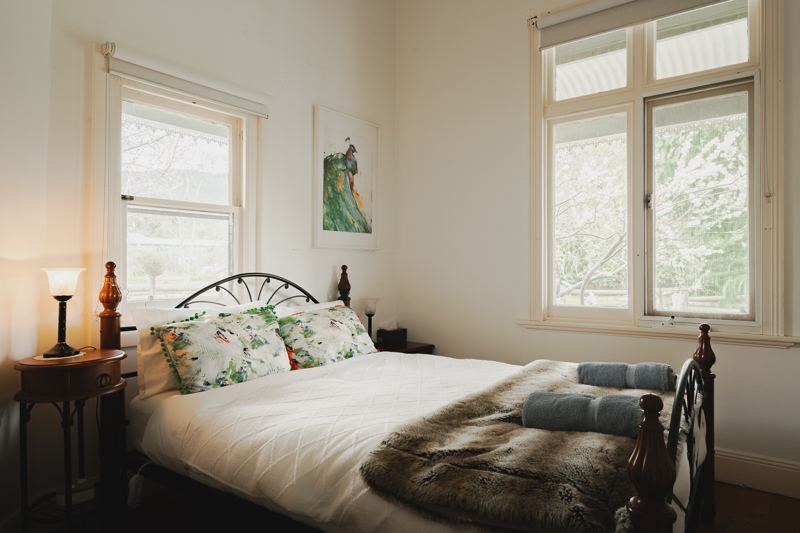 A queen bedroom with garden windows